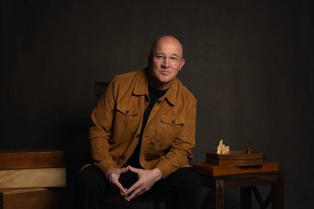 Stephen L. Keller seated for Pay to Play author movement portrait